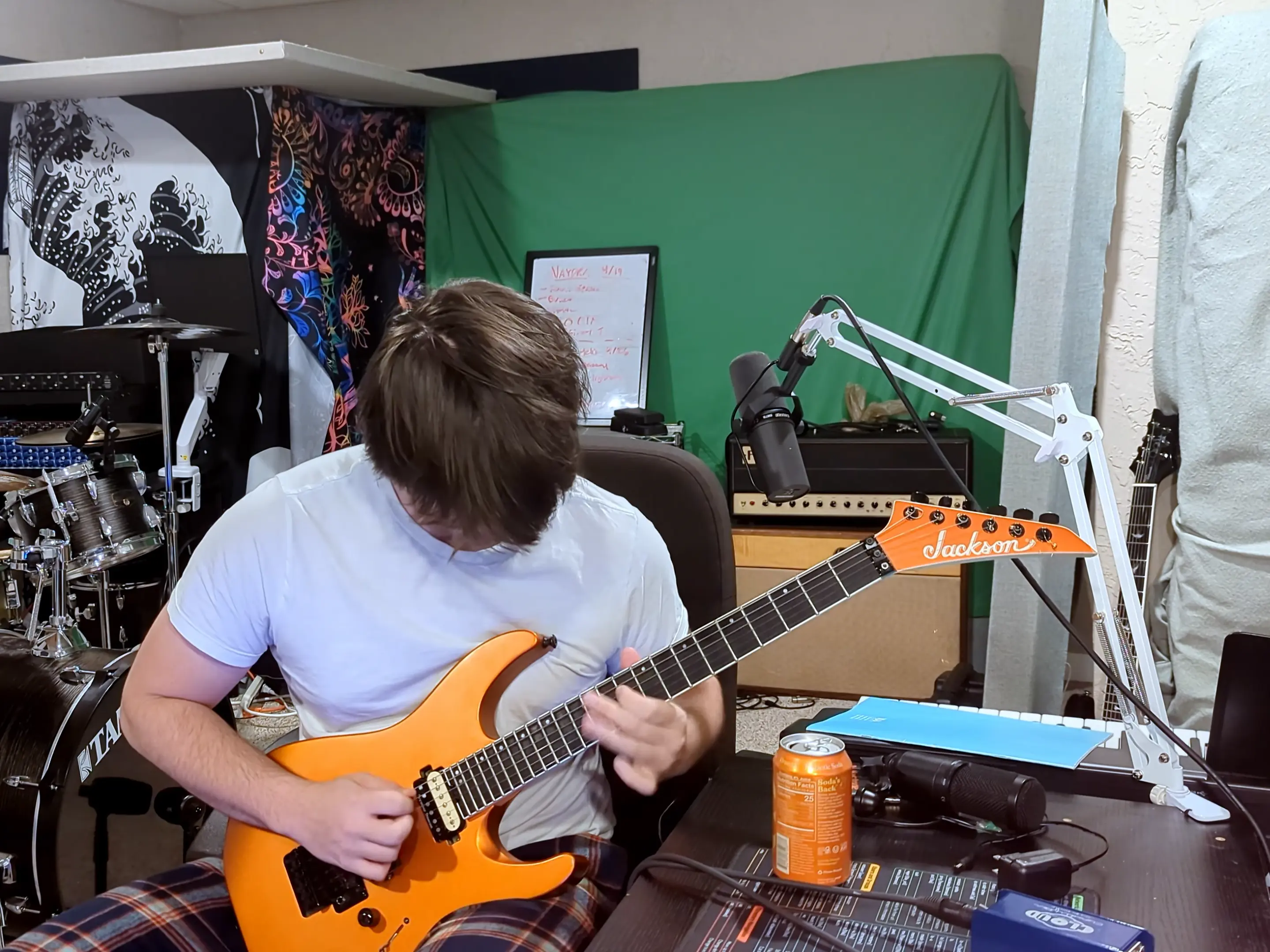Benny Mayer plays a guitar in a studio